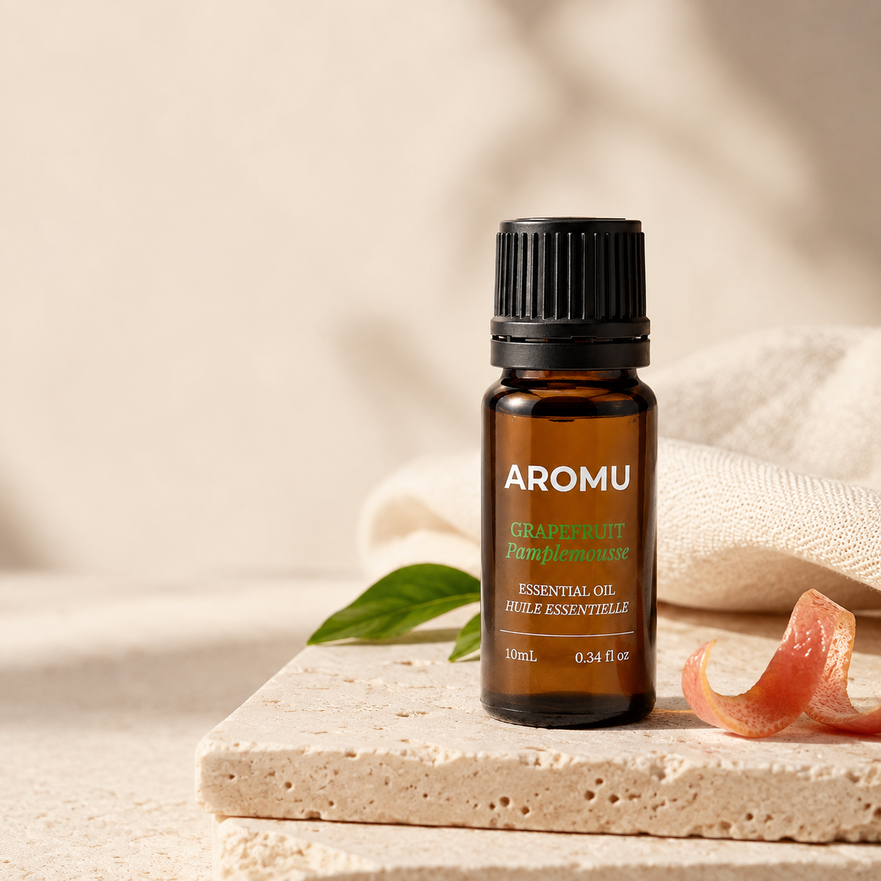 AROMU Grapefruit Essential Oil in warm natural light