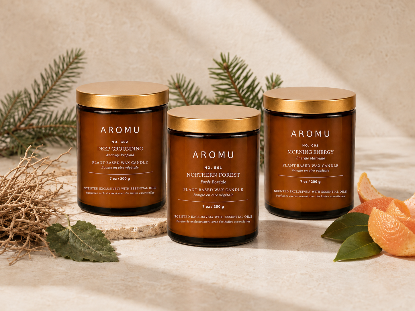 Three AROMU essential oil candles with spruce, grounding roots and citrus botanicals