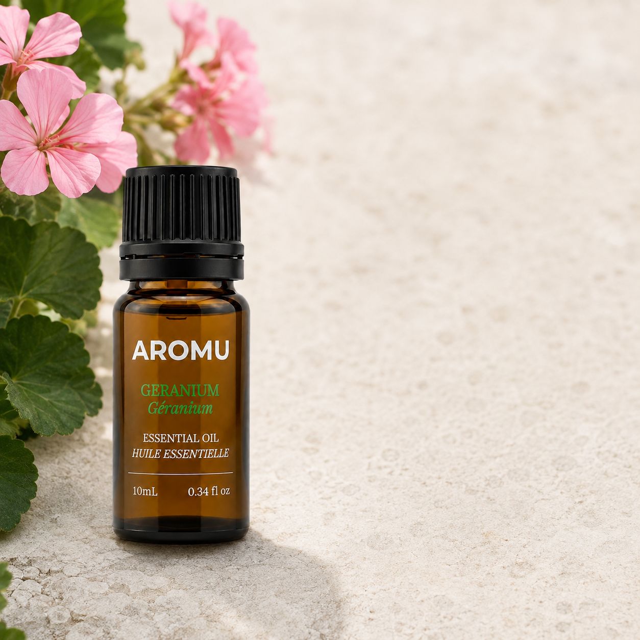 Geranium Essential Oil with pink geranium blossoms