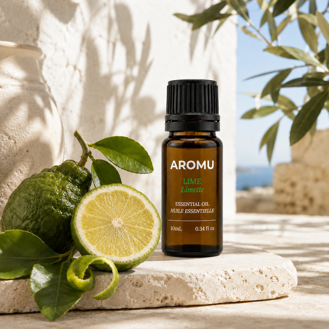 AROMU Lime Essential Oil with fresh lime and citrus leaves